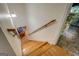 View of the hardwood stairway with a wooden handrail leading to the lower level of the home at 2000 Campbell Rd, Covington, GA 30014
