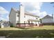 Rear exterior with a wooden deck, beige siding, and a storage shed in the backyard at 65 Heaton Place Trl, Covington, GA 30016