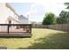 Spacious backyard featuring a large wooden deck and a well-maintained lawn at 65 Heaton Place Trl, Covington, GA 30016
