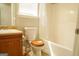 Bathroom view showcases a toilet with wooden seat, vanity, and shower/tub with curtain at 65 Heaton Place Trl, Covington, GA 30016