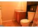 Bathroom featuring toilet, sink and flooring at 65 Heaton Place Trl, Covington, GA 30016