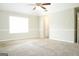 Neutral bedroom featuring carpeted flooring, one fan, and freshly painted walls at 65 Heaton Place Trl, Covington, GA 30016
