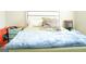 Bedroom with bed, turquoise nightstand, and orange boxes at 65 Heaton Place Trl, Covington, GA 30016