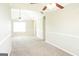 Neutral bedroom featuring carpeted flooring, two fans, and freshly painted walls at 65 Heaton Place Trl, Covington, GA 30016