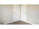 Bedroom showcasing closet doors and neutral carpet at 65 Heaton Place Trl, Covington, GA 30016