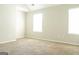 Bedroom boasting neutral walls, carpet, and ample natural light at 65 Heaton Place Trl, Covington, GA 30016