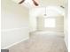 Neutral bedroom featuring carpeted flooring, two fans, and freshly painted walls at 65 Heaton Place Trl, Covington, GA 30016