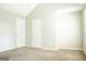 Neutral bedroom showcasing carpet and closet doors at 65 Heaton Place Trl, Covington, GA 30016