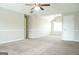 Neutral bedroom featuring carpeted flooring, two fans, and freshly painted walls at 65 Heaton Place Trl, Covington, GA 30016