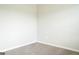 Empty bedroom with neutral walls and carpet, and a window letting in natural light at 65 Heaton Place Trl, Covington, GA 30016