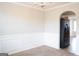 Bright dining area features wainscoting, chandelier and an arched doorway to an adjacent room at 65 Heaton Place Trl, Covington, GA 30016