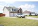 Beautiful two-story home with brick and siding, a two-car garage, and a lush green lawn at 65 Heaton Place Trl, Covington, GA 30016