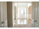 Inviting foyer with a white front door flanked by sidelights, tile flooring, and decorative archways at 65 Heaton Place Trl, Covington, GA 30016