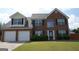 Beautiful brick home with a well-manicured lawn and a two-car garage at 65 Heaton Place Trl, Covington, GA 30016