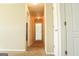 Bright hallway featuring neutral walls and carpets offers seamless transition between rooms at 65 Heaton Place Trl, Covington, GA 30016