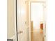 Bright hallway with a glimpse into the bathroom with wood cabinetry at 65 Heaton Place Trl, Covington, GA 30016