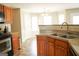 Traditional kitchen with stainless steel sink, appliances, countertops, and wooden cabinets at 65 Heaton Place Trl, Covington, GA 30016