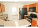 A modern kitchen with stainless steel appliances and views to a living space at 65 Heaton Place Trl, Covington, GA 30016