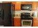 This modern kitchen is equipped with stainless steel appliances and wood cabinets at 65 Heaton Place Trl, Covington, GA 30016