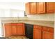 A well appointed kitchen with stainless steel sink and wood cabinets at 65 Heaton Place Trl, Covington, GA 30016