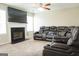 Living room boasts a fireplace, large tv and a reclining sectional sofa perfect for entertaining at 65 Heaton Place Trl, Covington, GA 30016