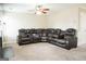 Bright living room showcasing plush carpeting, a large sectional sofa and neutral paint colors throughout at 65 Heaton Place Trl, Covington, GA 30016