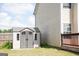Storage shed with double doors, adjacent to the house and deck, offering storage solutions at 65 Heaton Place Trl, Covington, GA 30016