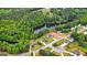 Aerial view of homes near lake with lush green surroundings at 447 W Wind Dr, Villa Rica, GA 30180