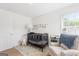 Well-lit Bedroom with crib, comfortable chair, and charming decor at 447 W Wind Dr, Villa Rica, GA 30180
