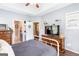 Bright bedroom features a ceiling fan, hardwood floors and a connecting bathroom at 447 W Wind Dr, Villa Rica, GA 30180