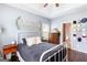 Comfortable bedroom with dark wood floors, ample natural light, and a white metal bed frame at 447 W Wind Dr, Villa Rica, GA 30180