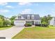 Charming two-story home with a well-manicured lawn and a two-car garage at 447 W Wind Dr, Villa Rica, GA 30180