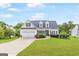 Charming two-story home featuring a well-manicured lawn and attached two-car garage at 447 W Wind Dr, Villa Rica, GA 30180
