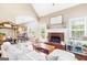 Bright living room features a brick fireplace, vaulted ceiling, and an abundance of natural light at 447 W Wind Dr, Villa Rica, GA 30180