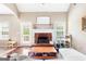 Cozy living room featuring a brick fireplace, mantel, and an abundance of natural light at 447 W Wind Dr, Villa Rica, GA 30180