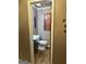 A half-bathroom features a wood-trimmed vanity, an elongated toilet, and decorative wall art at 1685 Bailey Creek Sw Rd, Conyers, GA 30094