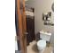 Bathroom with tile floors featuring a toilet and shower with dark wooden door at 1685 Bailey Creek Sw Rd, Conyers, GA 30094