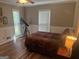 Bedroom featuring hardwood floors, a telescope, and a window with natural light at 1685 Bailey Creek Sw Rd, Conyers, GA 30094