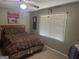 Bedroom with ceiling fan features natural light from window adjacent to bed at 1685 Bailey Creek Sw Rd, Conyers, GA 30094
