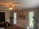 Bedroom featuring a ceiling fan, wainscotting and a window with natural light at 1685 Bailey Creek Sw Rd, Conyers, GA 30094