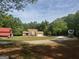 Expansive property featuring a spacious yard, barn, and large parking area for RVs or trailers at 1685 Bailey Creek Sw Rd, Conyers, GA 30094