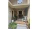 Inviting front porch with a welcoming rocking chair, plants, and stylish sconces at 1685 Bailey Creek Sw Rd, Conyers, GA 30094