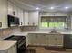 Kitchen offers subway tile backsplash, white cabinets, and a stainless steel range and microwave at 1685 Bailey Creek Sw Rd, Conyers, GA 30094