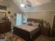 Cozy main bedroom with a ceiling fan, bedside lamps, and matching dressers at 1685 Bailey Creek Sw Rd, Conyers, GA 30094