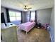 Bedroom with a window, ceiling fan, and carpet flooring at 140 Whitehead Sw Rd, Oxford, GA 30054