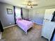 Bedroom with a window, ceiling fan, and carpet flooring at 140 Whitehead Sw Rd, Oxford, GA 30054