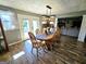 Dining area featuring a wooden table with seating for eight and access to outdoor spaces at 140 Whitehead Sw Rd, Oxford, GA 30054