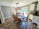 Dining room features wood floors, a large table with seating, and a modern chandelier for stylish entertaining at 140 Whitehead Sw Rd, Oxford, GA 30054