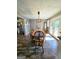 Dining area with an eight-seat wooden table, decorative lighting, and access to the backyard at 140 Whitehead Sw Rd, Oxford, GA 30054