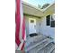 Charming front porch featuring a white door with glass panes and rustic wood flooring at 140 Whitehead Sw Rd, Oxford, GA 30054